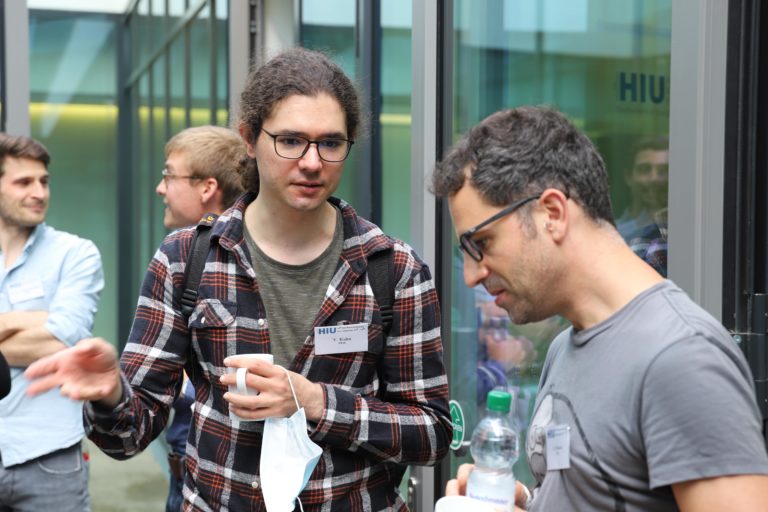 Photo of me, Yannick Kuhn, discussing something with my colleague Alejandro Somoza at the biennial conference of the Helmholtz Institute Ulm.